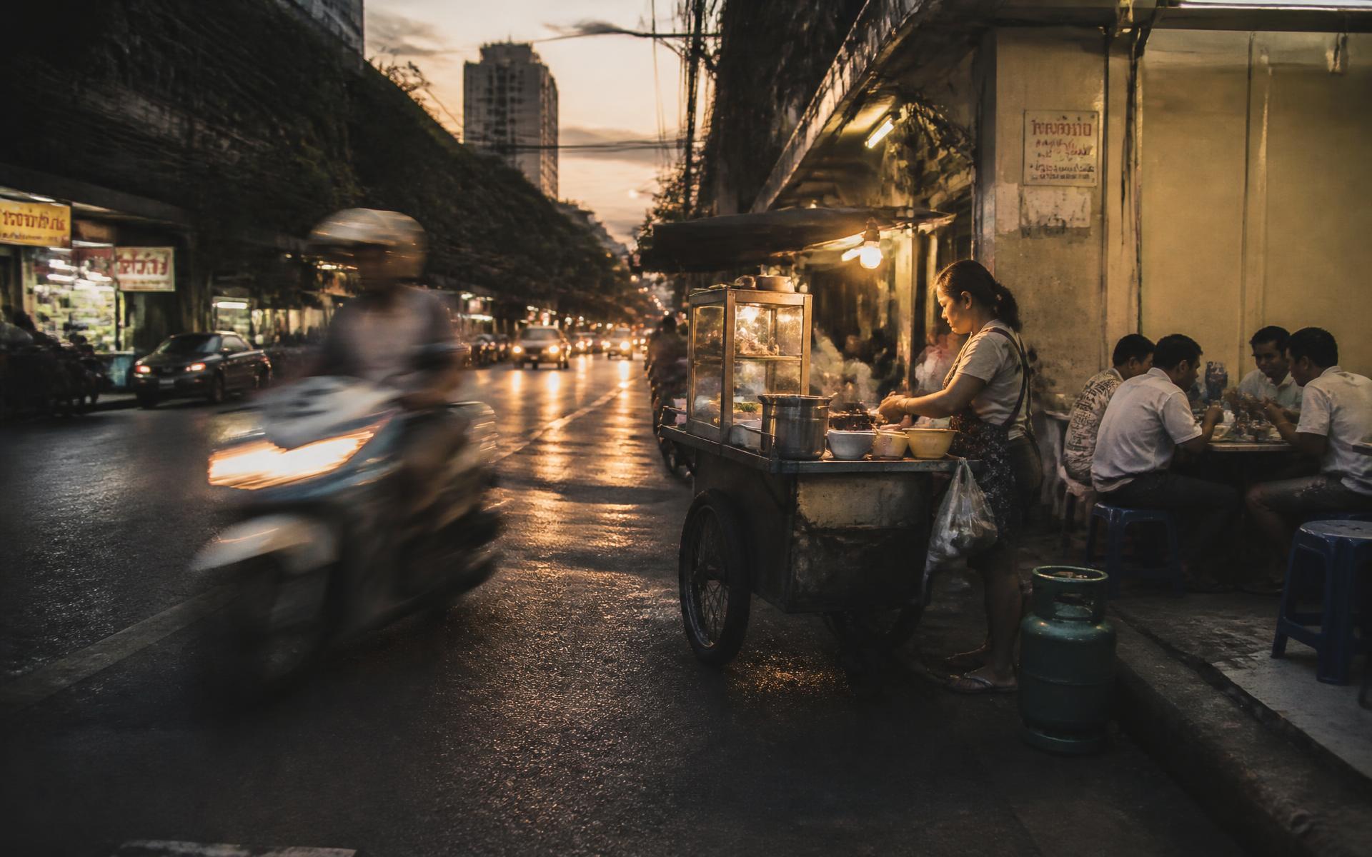A street food cart at dusk in Bangkok